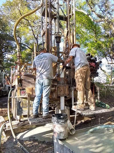 2 Bronco Boys busy working on a drilling rig